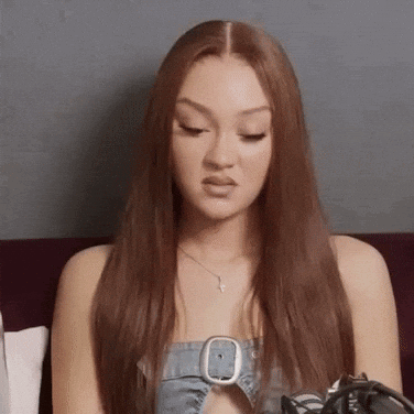 Red Hair Woman on Couch in Denim Top