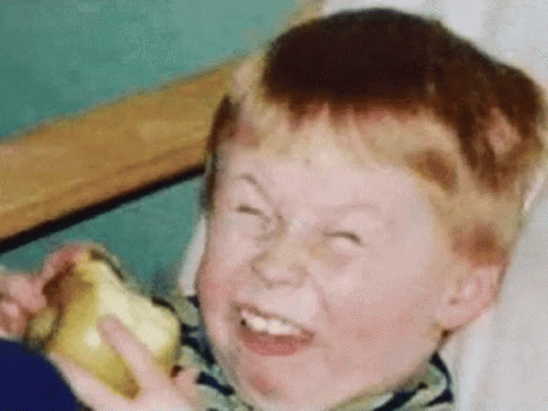 Red-Haired Boy Making Funny Face with Banana