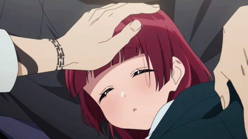 Red-Haired Girl Laying On Ground With Man's Hand On Forehead GIF