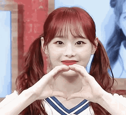 Red-Haired Girl Making Heart With Hands