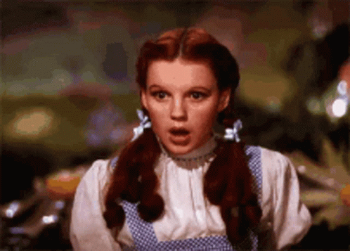 Red-Haired Pigtailed Woman In Blue Polka Dot Dress GIF