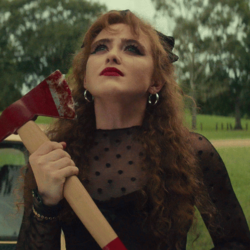 Red-Haired Woman Holding Bloody Axe