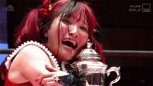Red Haired Woman Holding Silver Trophy GIF