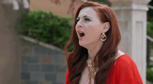 Red-Haired Woman In Earrings And Red Dress GIF