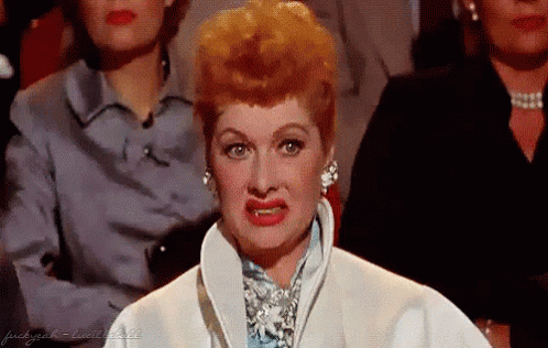 Red-Haired Woman In White Coat Making Funny Face GIF