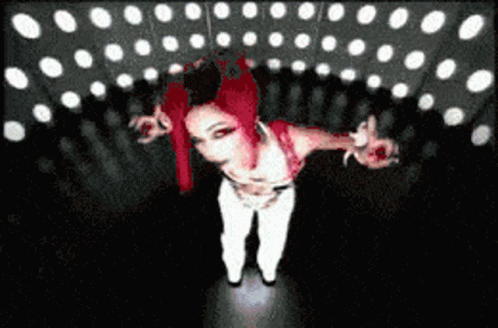 Red-Haired Woman In White Pants In Dark Room GIF