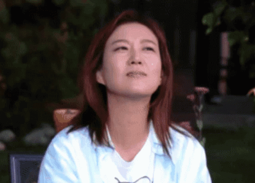 Red-Haired Woman Looking Up at Sky