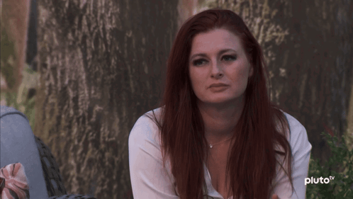 Red-Haired Woman Sitting by Tree Pluto TV