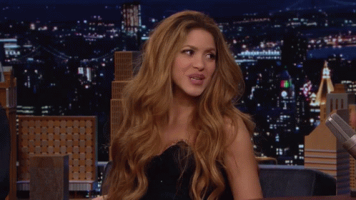 Red-Haired Woman Smiling At Night Skyline GIF