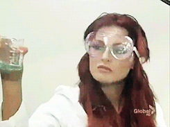 Red-Haired Woman Wearing Goggles Holding Glass