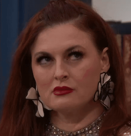 Red-Haired Woman with Necklace Earrings Making Funny Face
