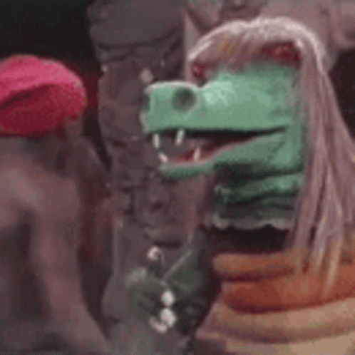 Red Hat Man Next to Dinosaur Puppet
