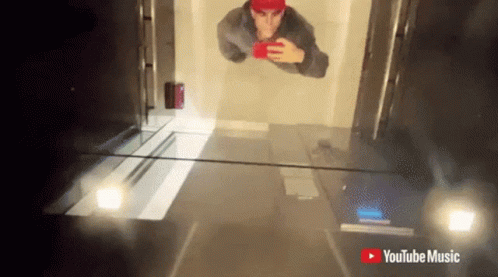 Red Hat Man Selfie With YouTube Music Logo GIF