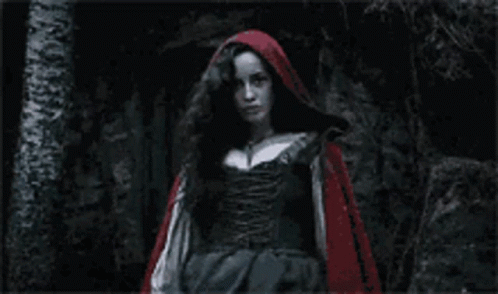 Red Hooded Woman Standing In Dark GIF