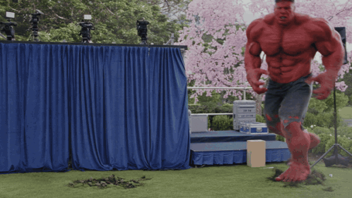 Red Hulk Standing in Front of Stage