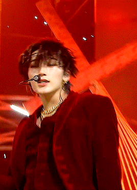Red Jacket Gold Necklace Man Singing Into Microphone