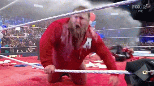 Red Jacket Man With 'A' Kneeling Wrestling Ring GIF