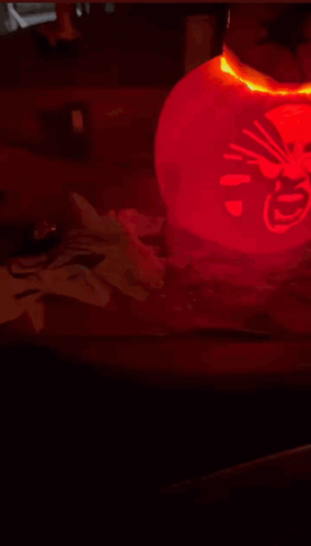 Red Lantern with Chinese Writing Lit Up in Dark