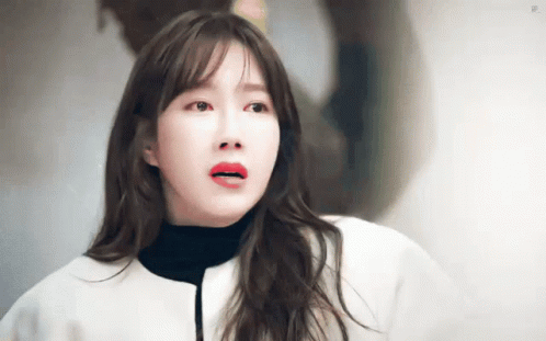 Red-Lipped Woman in White Jacket and Black Turtleneck