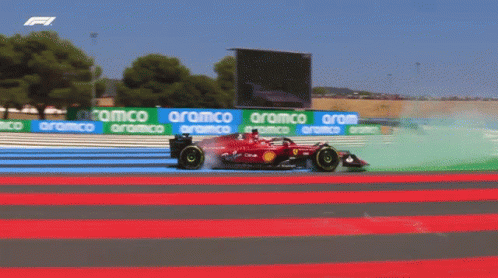 Red Race Car on Track with Aramco Banners