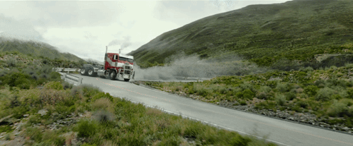 Red Semi Truck Driving on Mountain Road