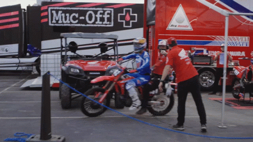 Red Shirt Man By Motorcycle With Muc-Off Sign GIF