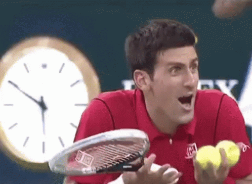 Red Shirt Man Holding Tennis Racquet and Balls