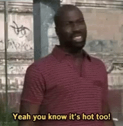 Red Shirt Man Smiling Saying Yeah You Know It's Hot Too
