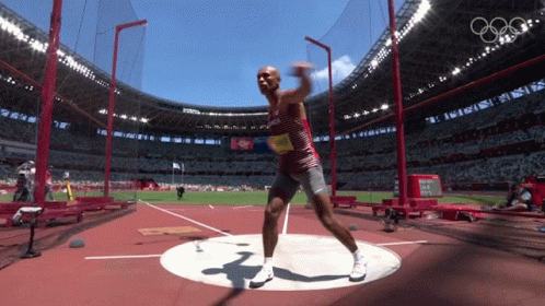 Red Shirt Man Throwing Disc in Stadium