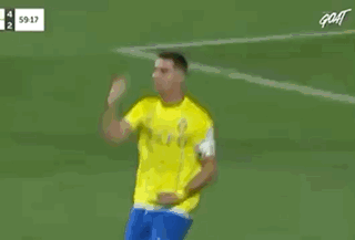 Red Shirt Referee Talking to Yellow Shirt Soccer Player