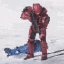 Red Soldier Standing by Laying Person with Gun