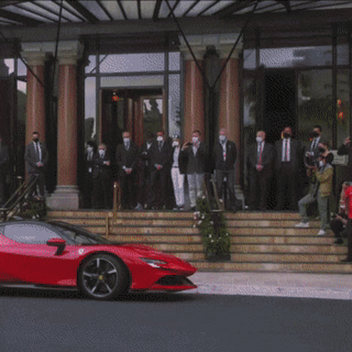 Red Sports Car and Group of People