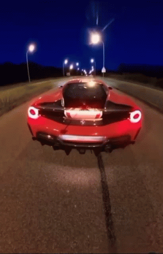 Red Sports Car Driving at Night