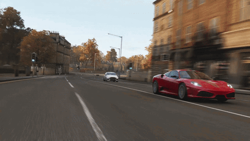 Red Sports Car Driving Next to White Sports Car