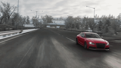 Red Sports Car With Black Hood Driving