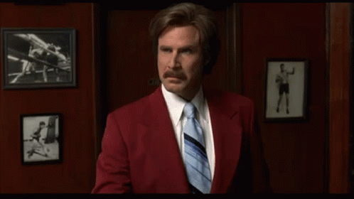 Red Suit Man Holding Paper With Blue Tie GIF