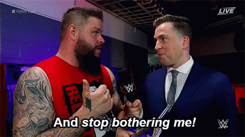 Red Tank Top Man Tells Suited Man Stop Bothering Me