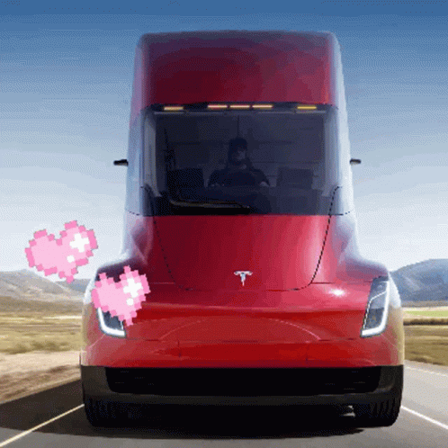 Red Tesla Truck Driving With Two Pink Hearts