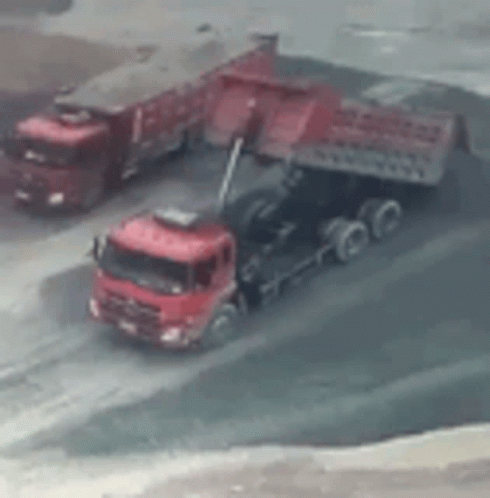 Red Trucks Parked On Dirt Road GIF
