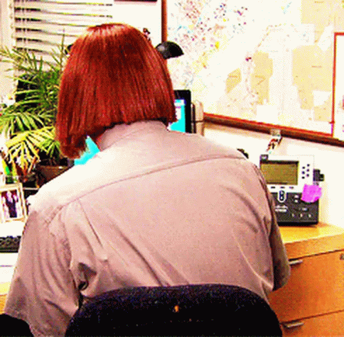 Redhead Woman at Desk With Telephone and Map