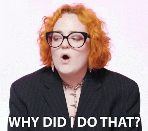 Redhead Woman in Glasses and Black Suit Saying Why Did I Do That