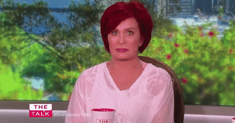 Redhead Woman Sitting With Coffee At Window GIF