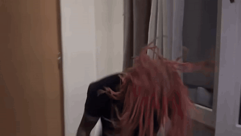 Redhead Woman Standing In Front Of Window Hair Blowing In Wind GIF