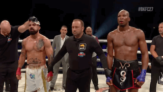 Referee Between Two Boxers in Ring