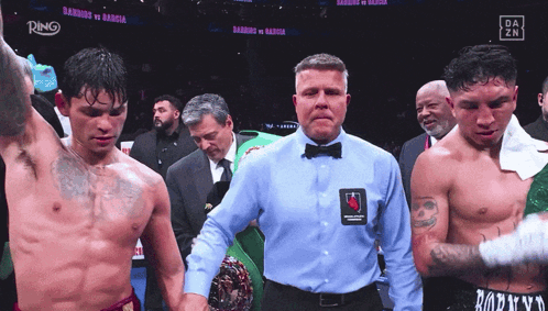 Referee Between Two Boxers With Ring