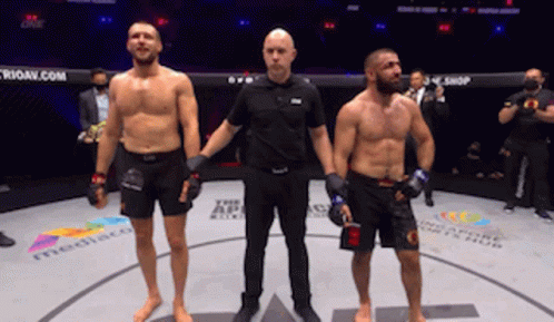 Referee Between Two Fighters in Ring