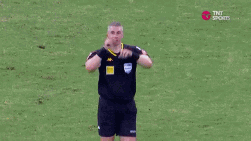 Referee Blowing Whistle Soccer Field