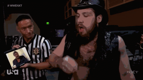 Referee Displays Photo To Second Wrestler GIF