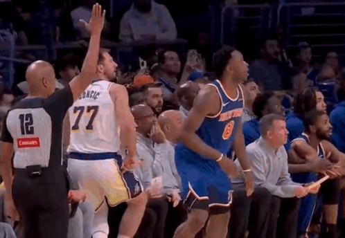 Referee Giving High Five to Basketball Player on Bench