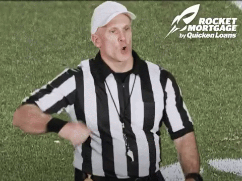 Referee in Black and White Striped Shirt on Football Field